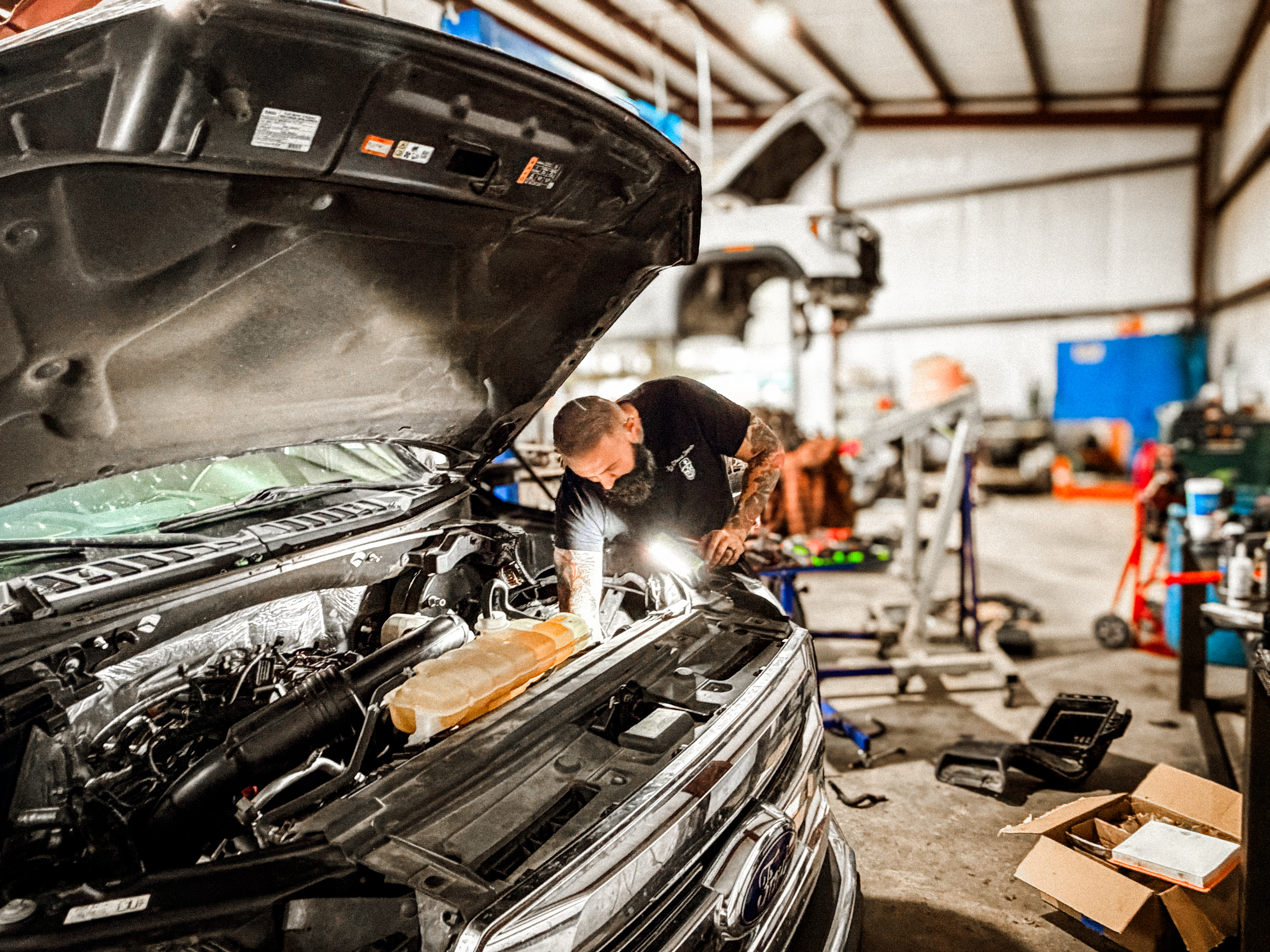 JD Diesel Repair mechanic working on a vehicle